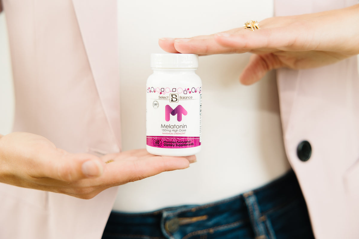 Stephanie Grutz holding a bottle of Select Balance Melatonin 150 mg High Dose